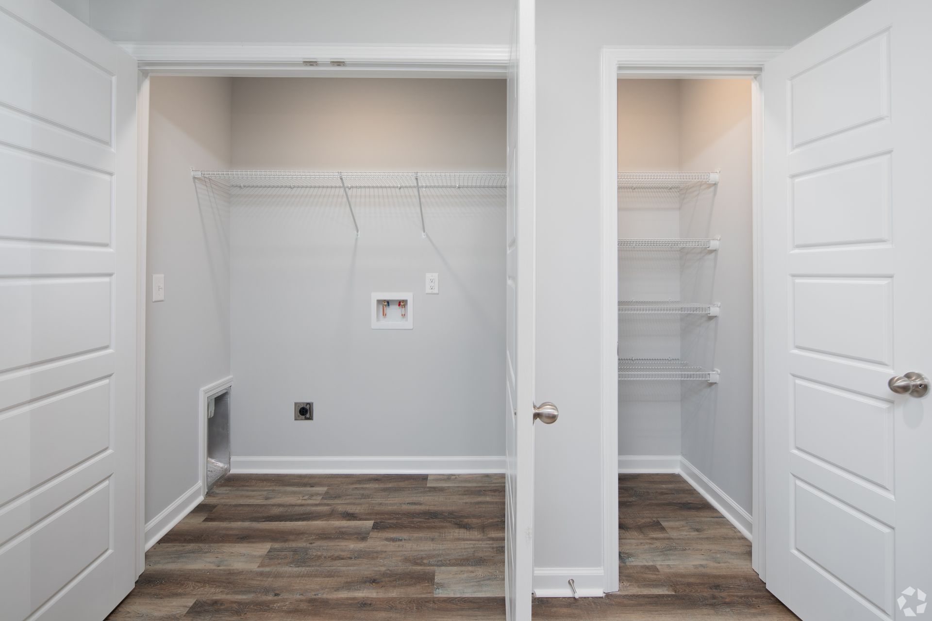 Laundry room with adjacent pantry, both with white doors, gray walls, and wire shelving.