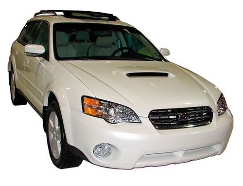 White Subaru Outback station wagon with roof rack.