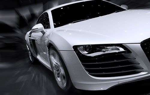 White sports car speeding, motion blur background.