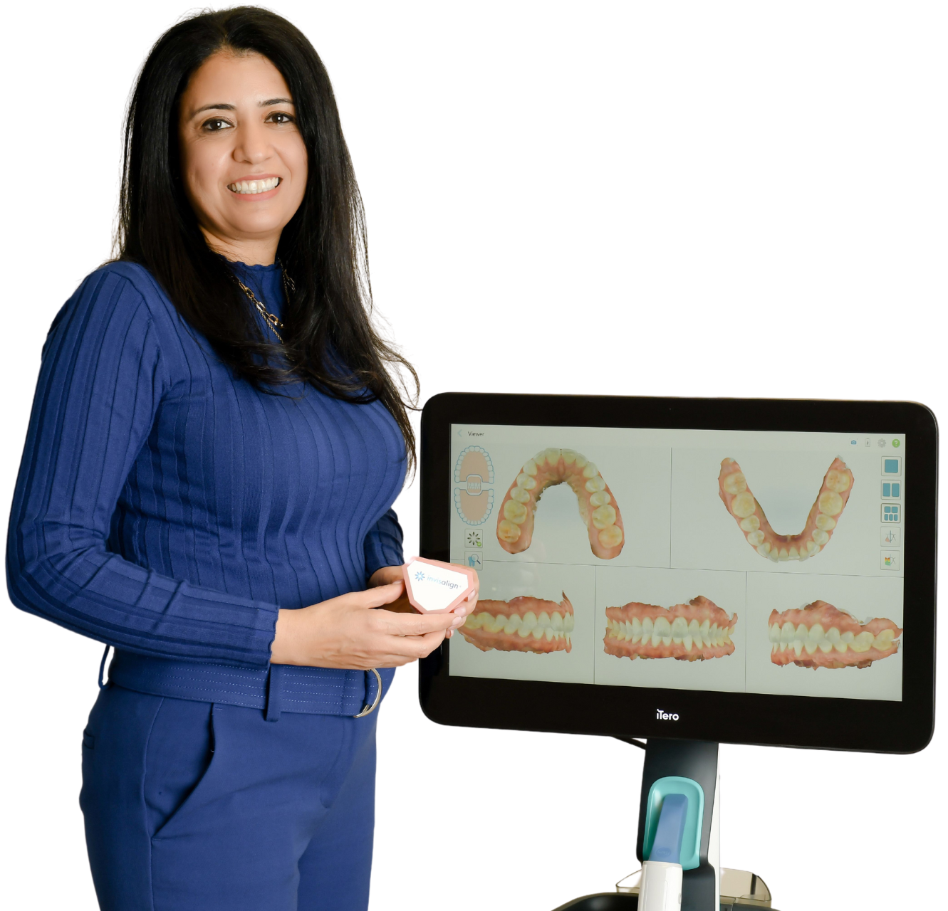 A woman in a blue sweater is standing next to a computer monitor