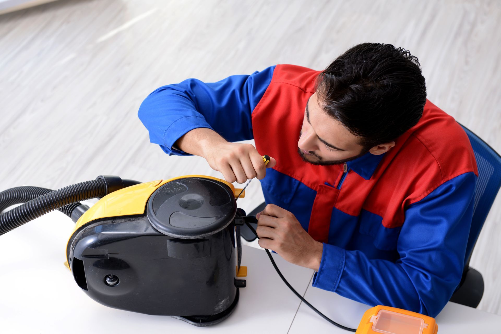 Man Repairing the Vacuum
