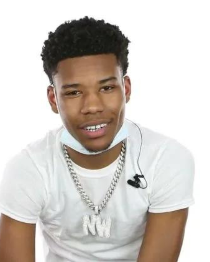 A young man wearing a white shirt and a chain around his neck.