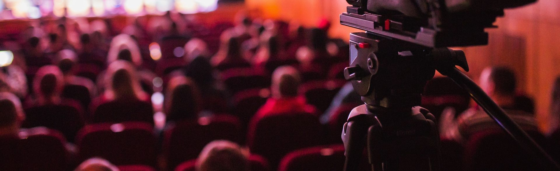 A person is holding a clapper board in front of a camera.
