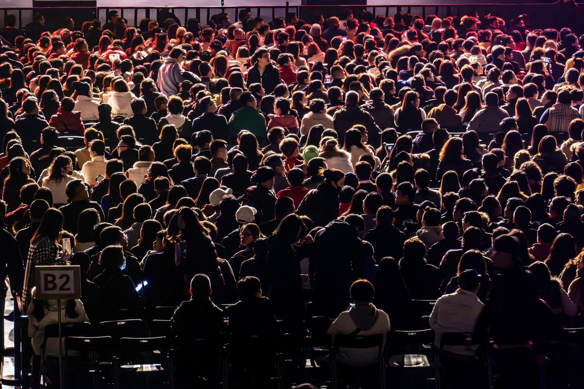 A crowd of people at a concert with a sign that says b2