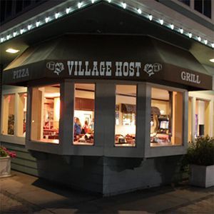 A restaurant called village host is located on the corner of a building