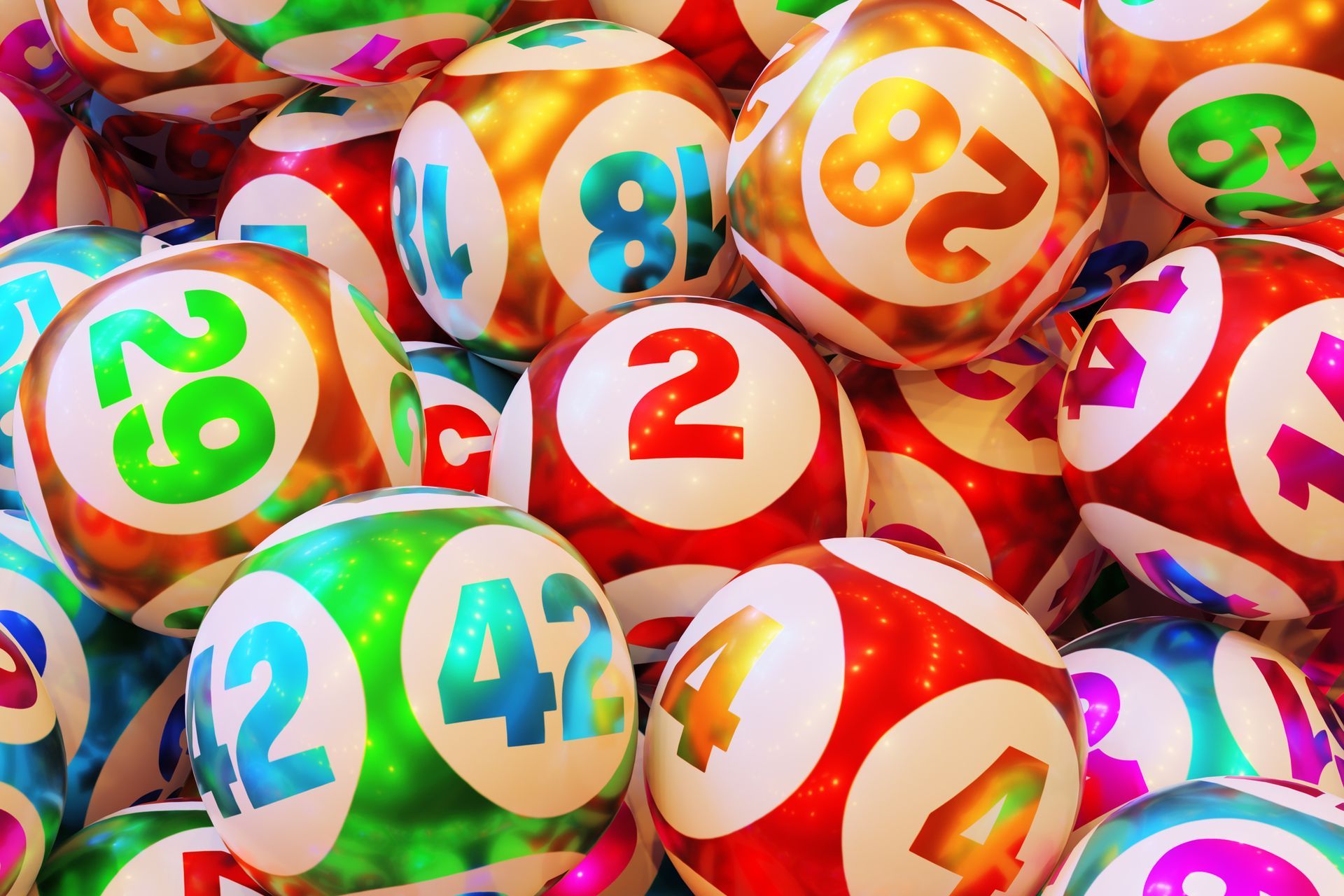 A pile of colorful lottery balls with numbers on them.