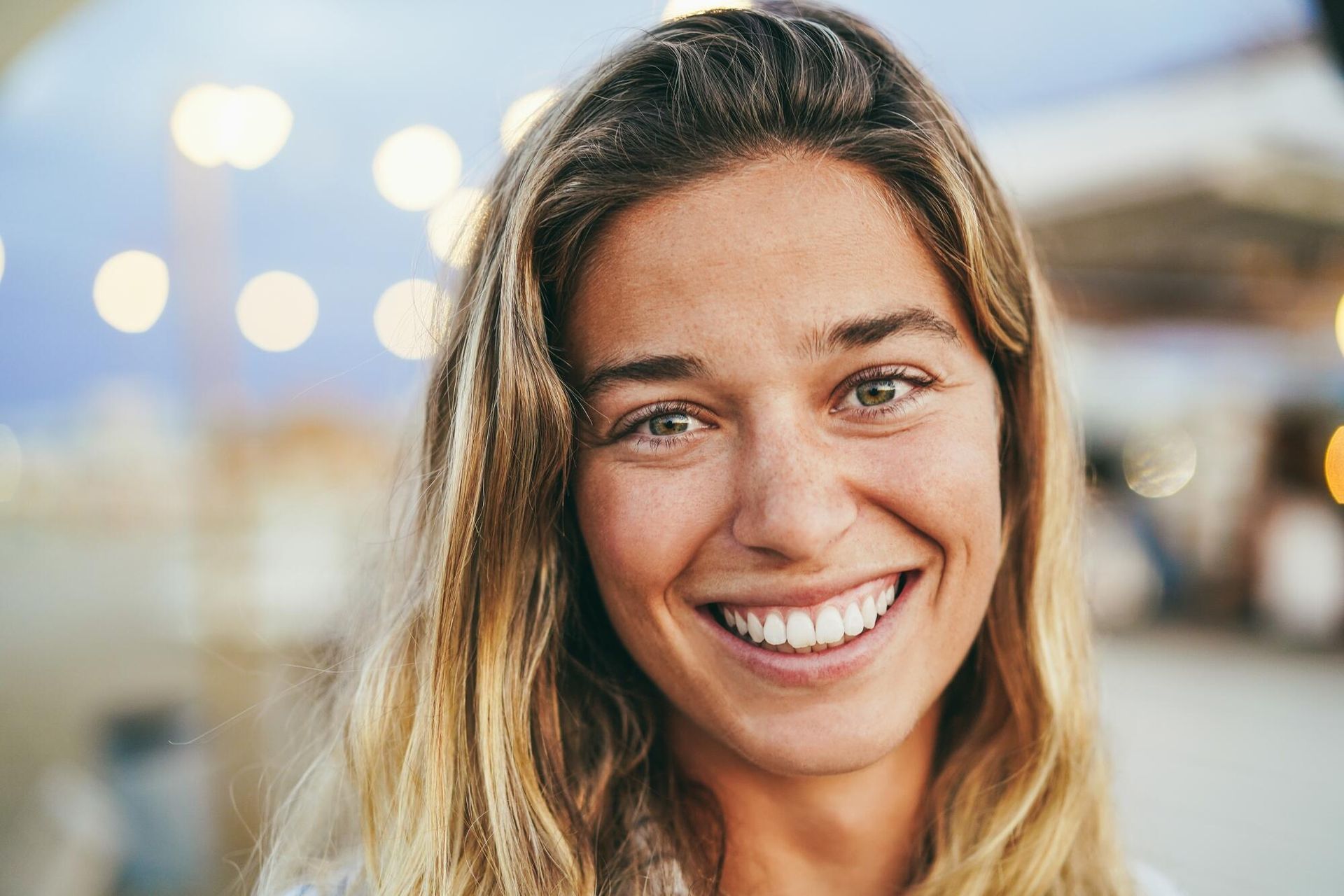A close up of a woman smiling for the camera.