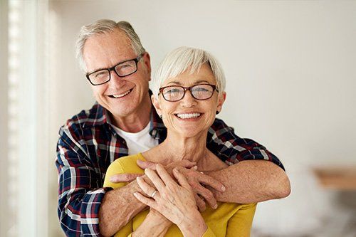 smiling senior couple embracing