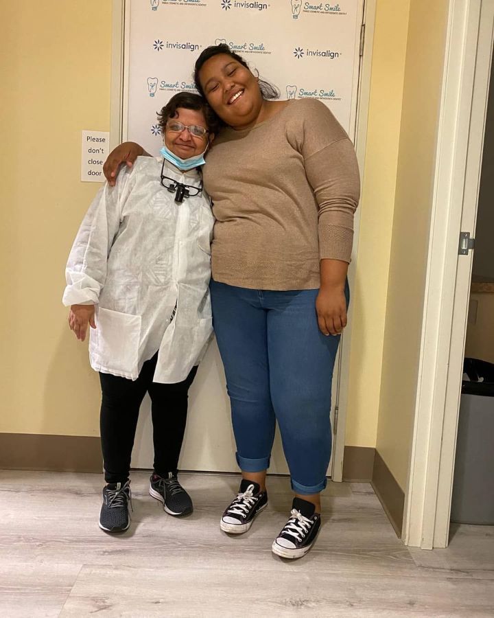 Two women are standing next to each other in a room.