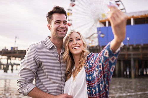 man and woman smiling for selfie
