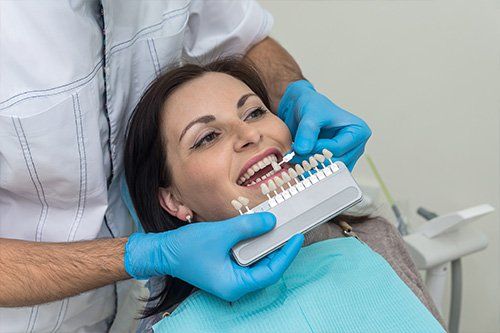 dentist color matching woman's teeth color