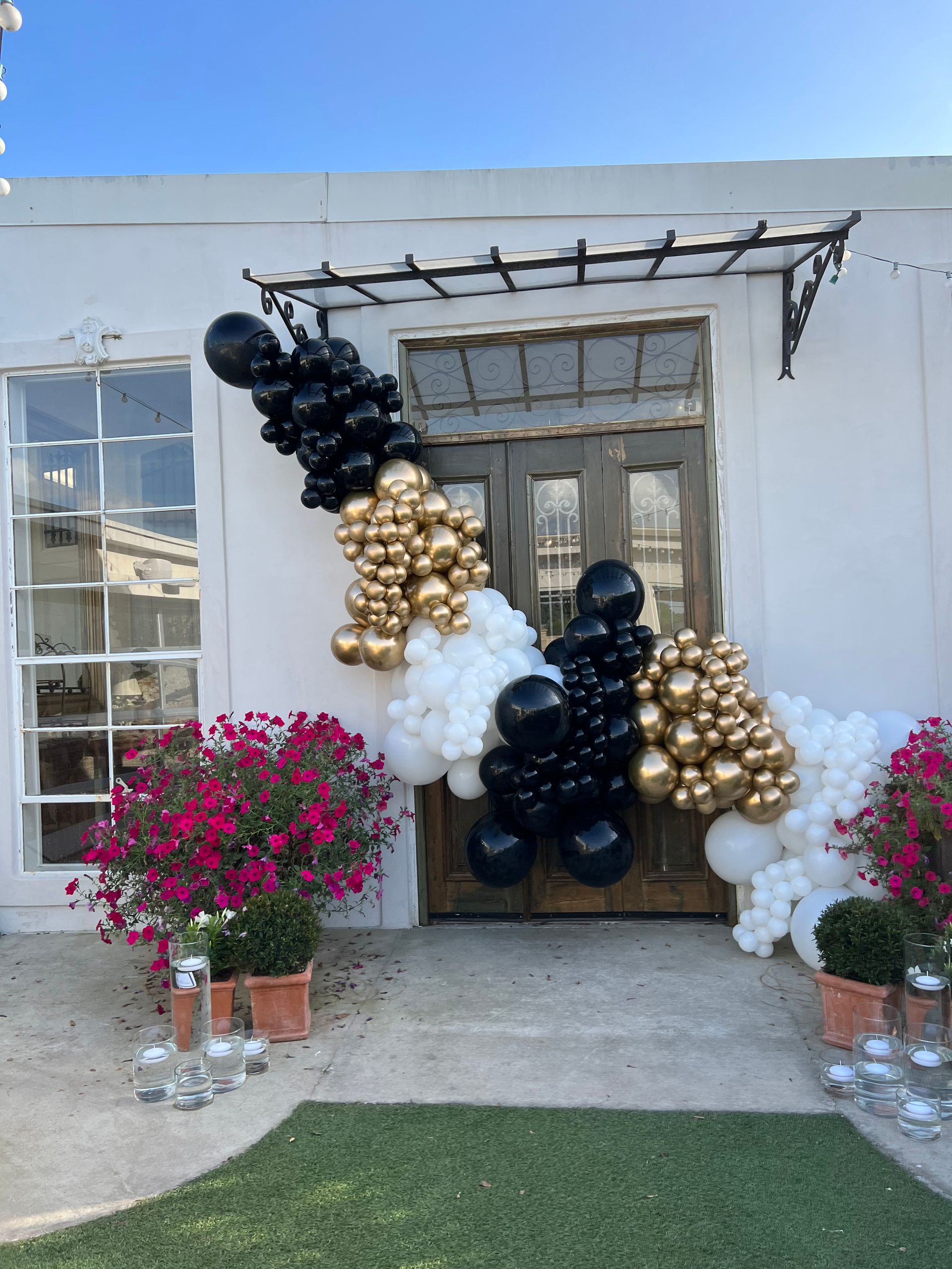 A building with balloons and flowers in front of it