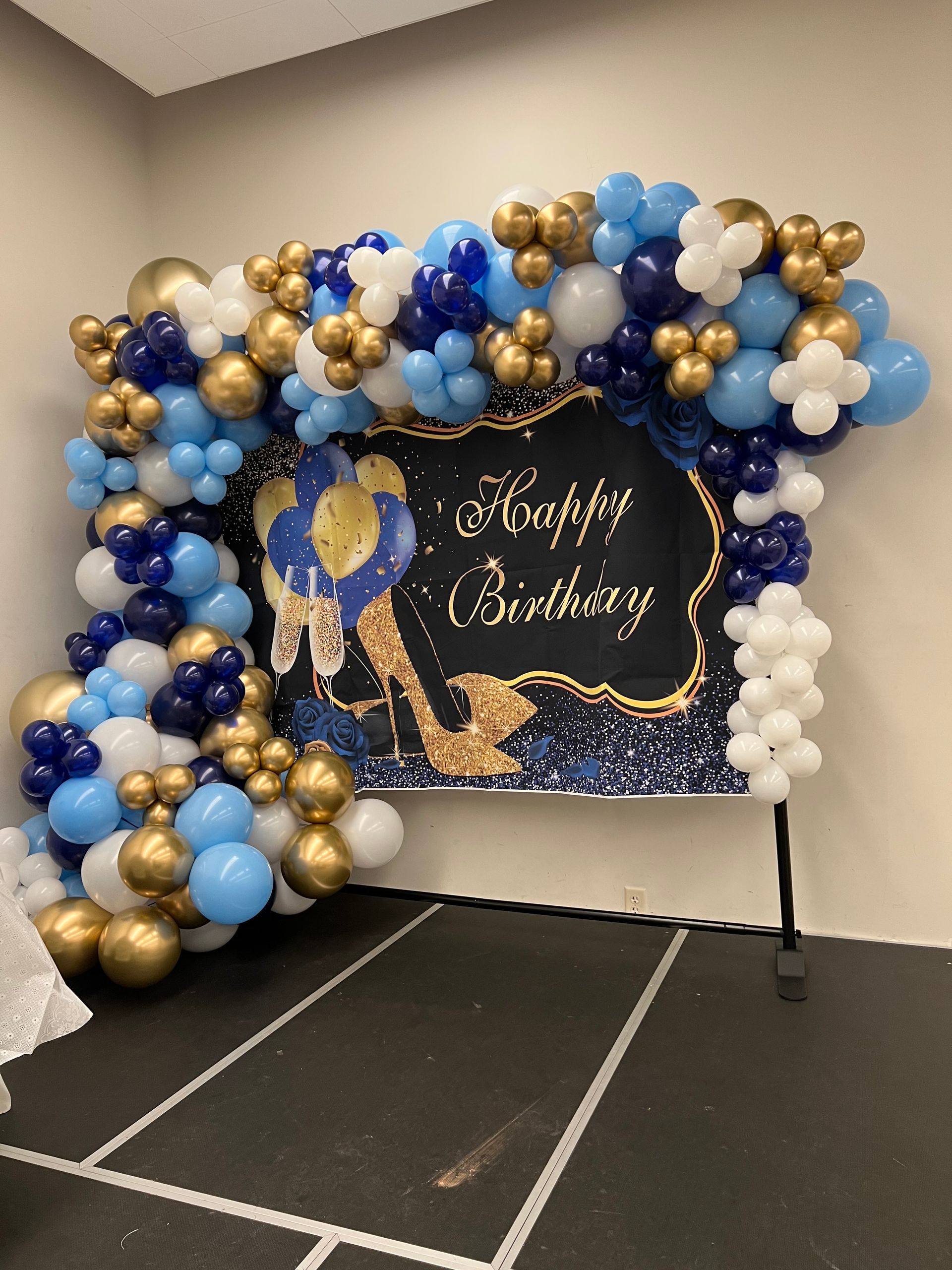 A room filled with balloons and a sign that says happy birthday.