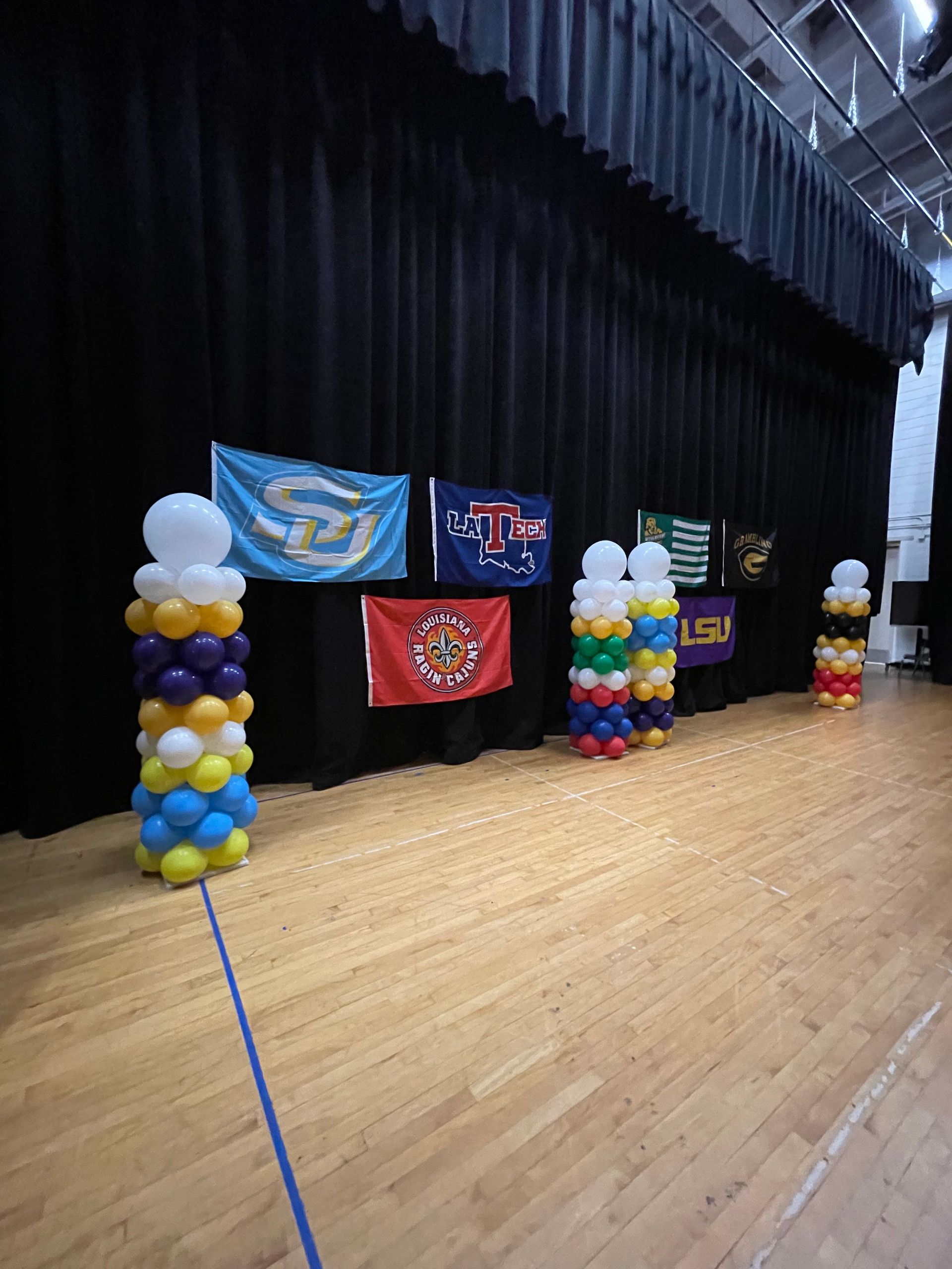 A stage with balloons and flags on it