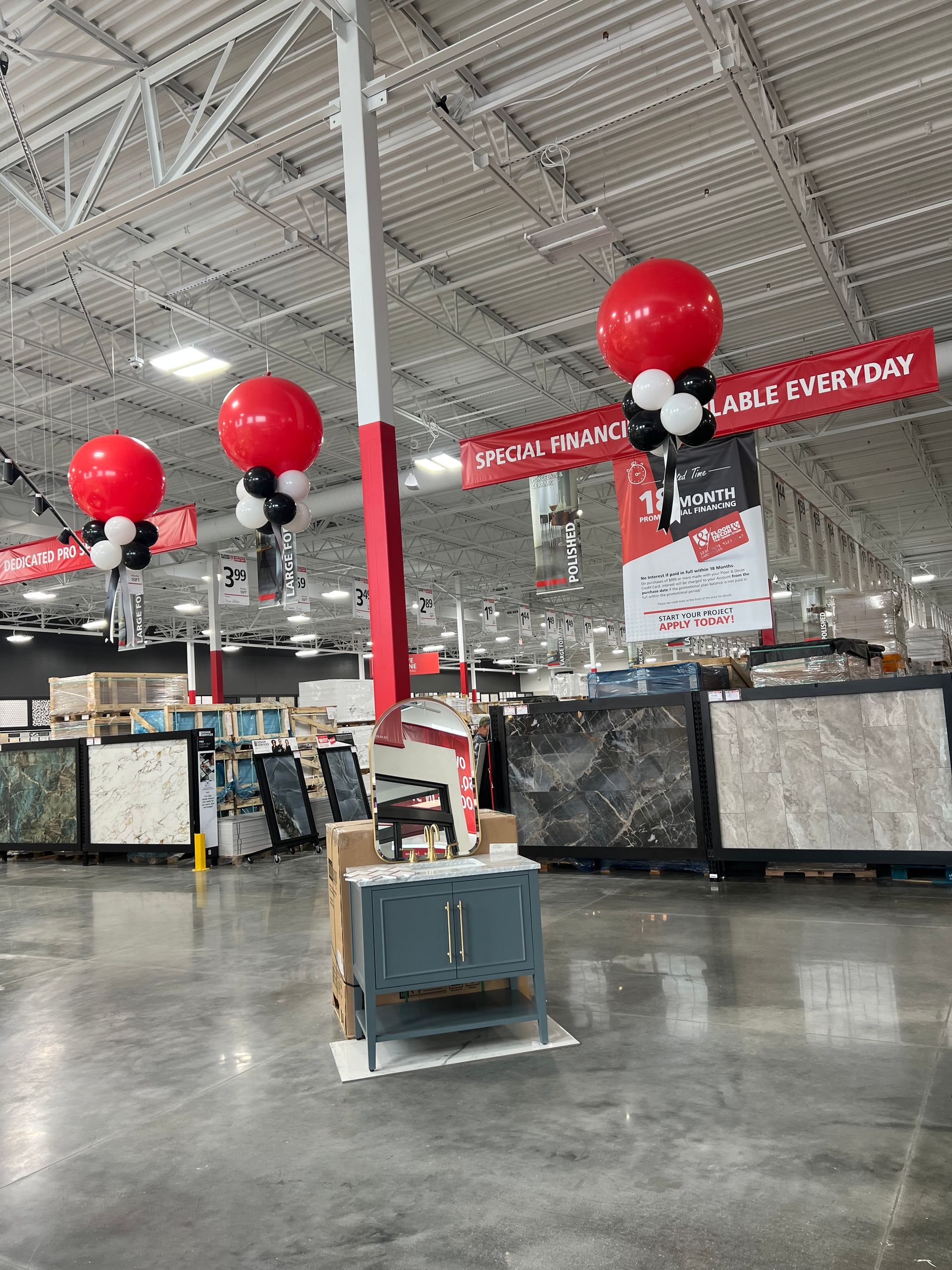 A large warehouse with balloons hanging from the ceiling.