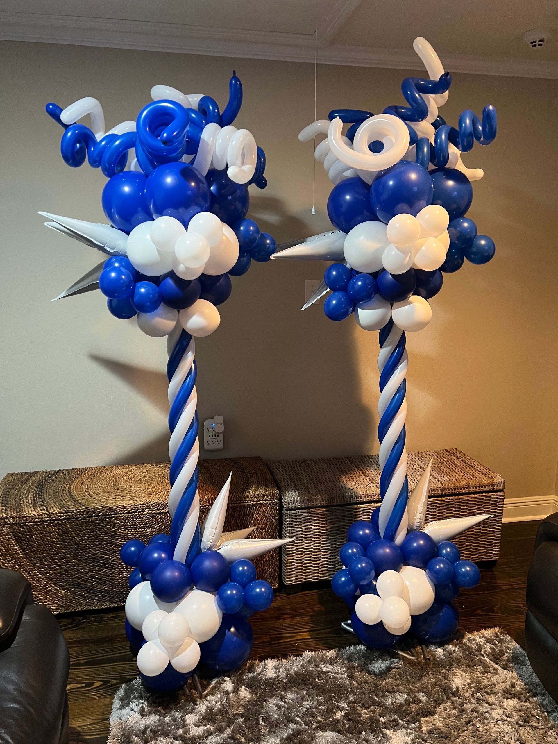 A couple of blue and white balloons sitting on top of a table.