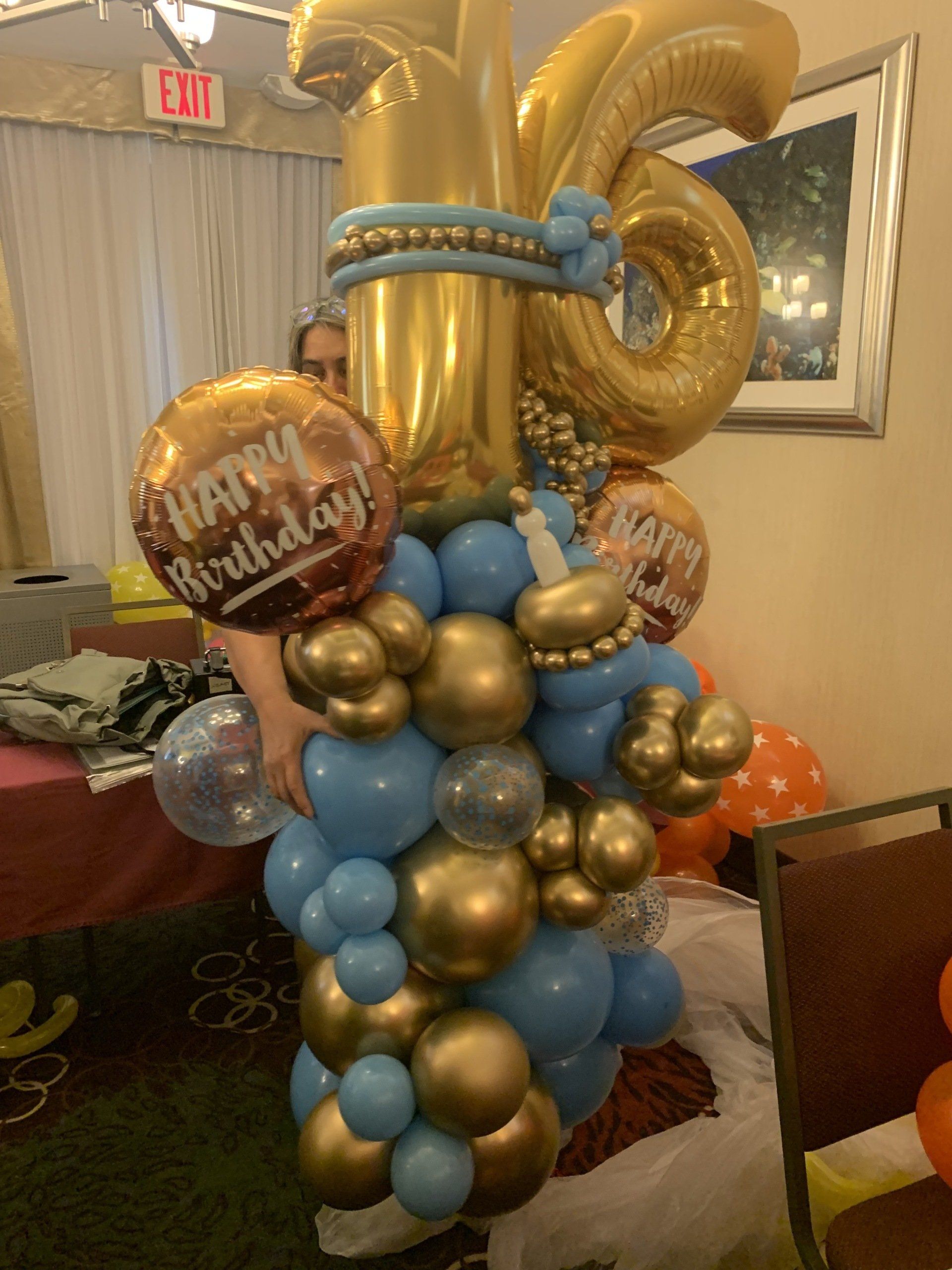 A bunch of balloons with one that says happy birthday