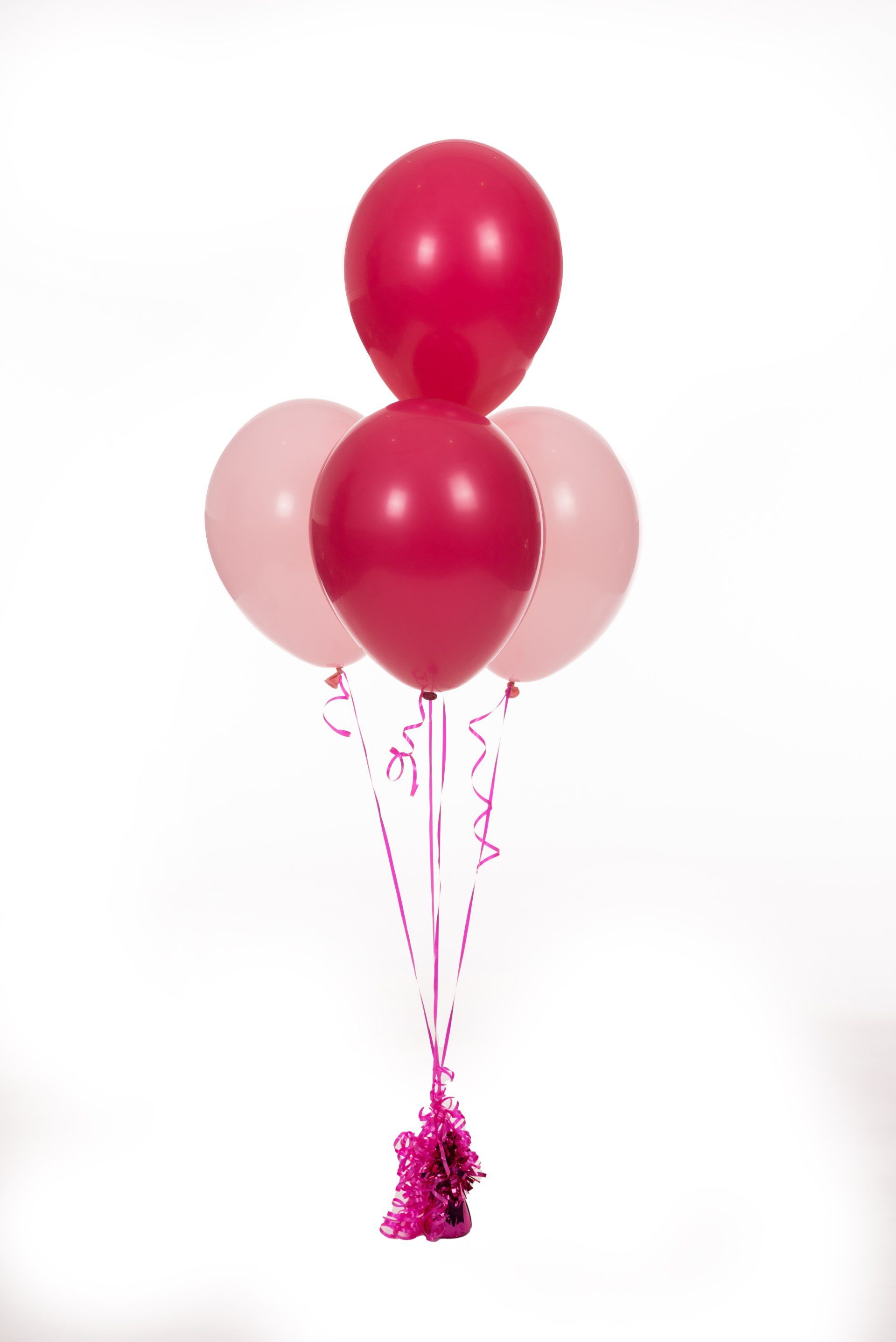 A bunch of pink and red balloons on a white background