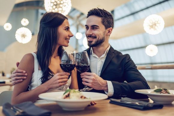 couple toasts in front of a dish
