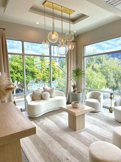 A living room with a couch , chairs , and a coffee table.