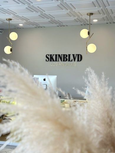 The inside of a skin blvd beauty salon with a sign on the wall.