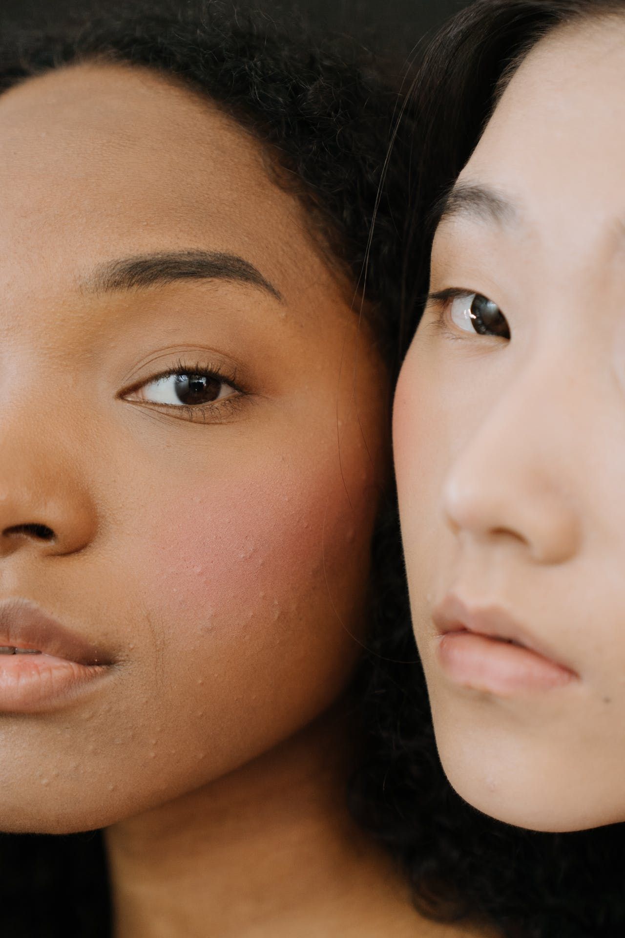 Two women are standing next to each other and looking at the camera.