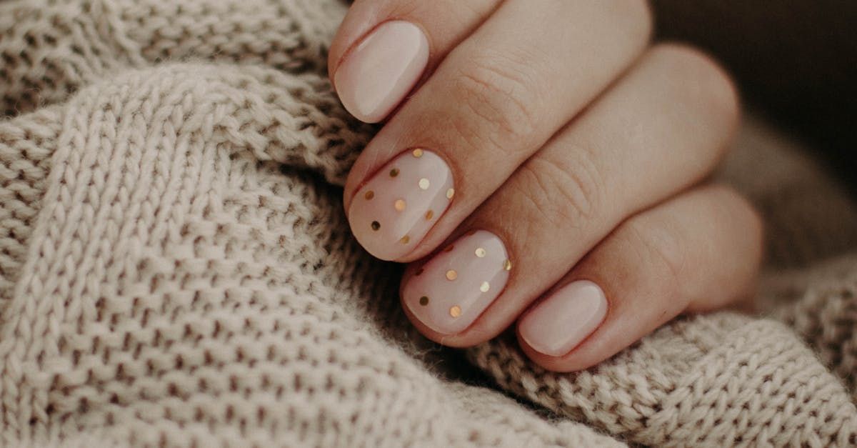 A close up of a woman 's nails on a sweater.