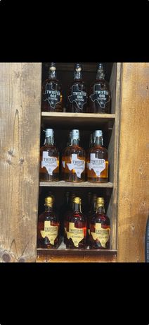 A wooden shelf filled with bottles of liquor.