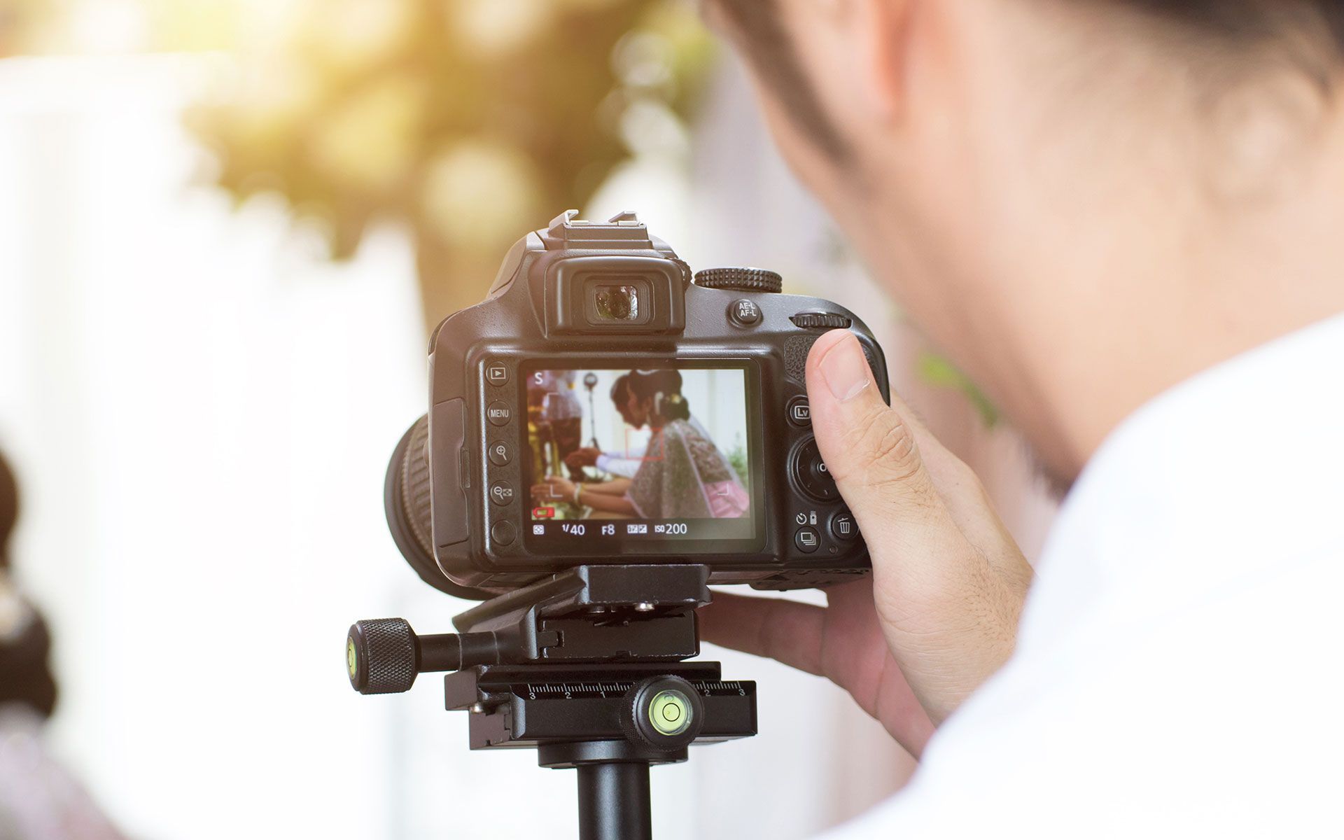 A person is taking a picture with a camera on a tripod.