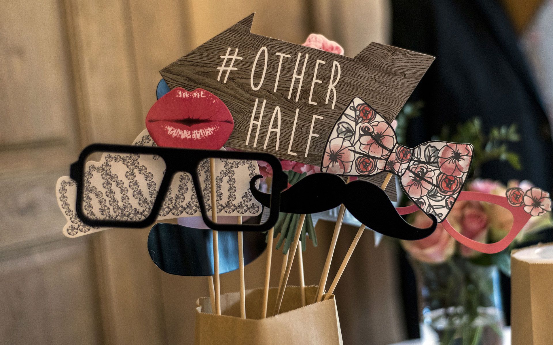 A bunch of photo booth props are sitting on a table.