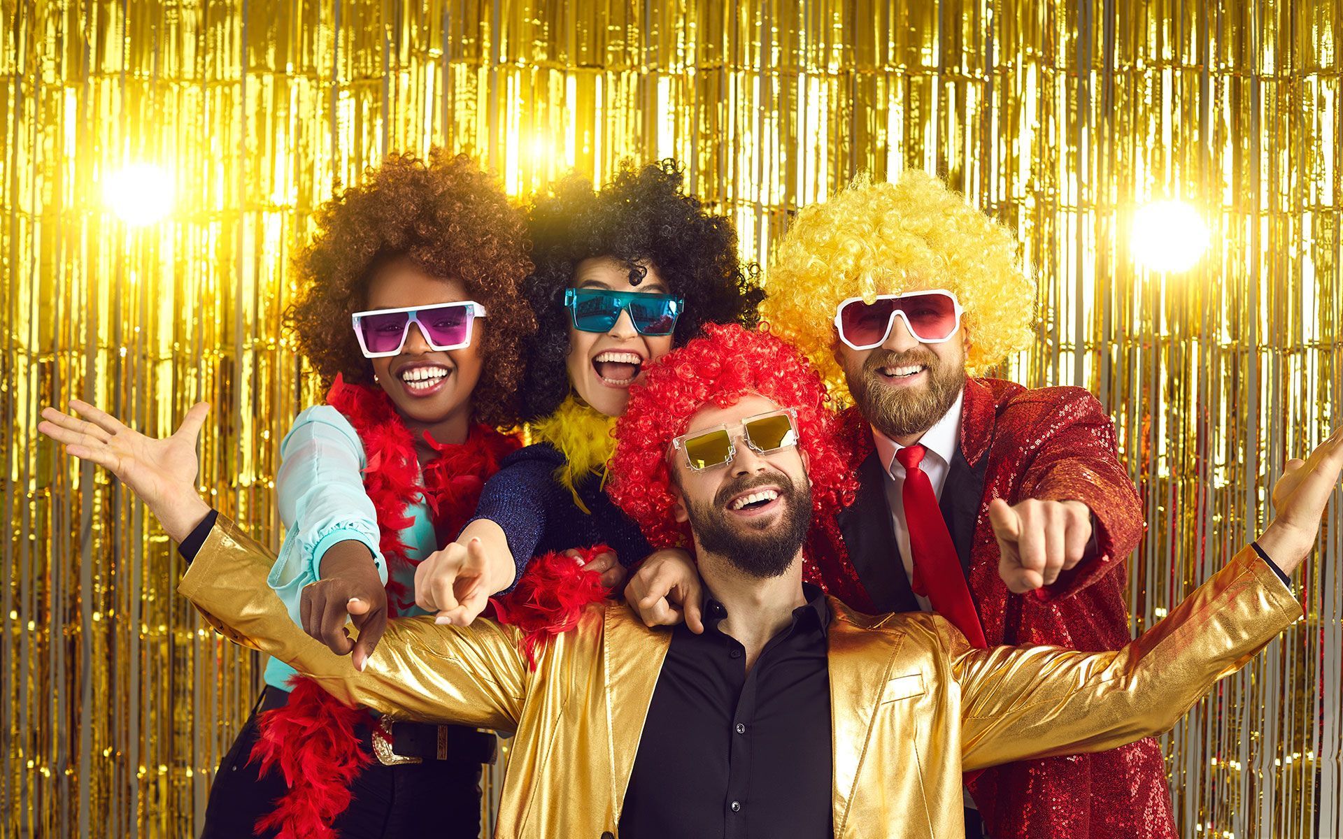 A group of people are posing for a picture in front of a gold curtain.