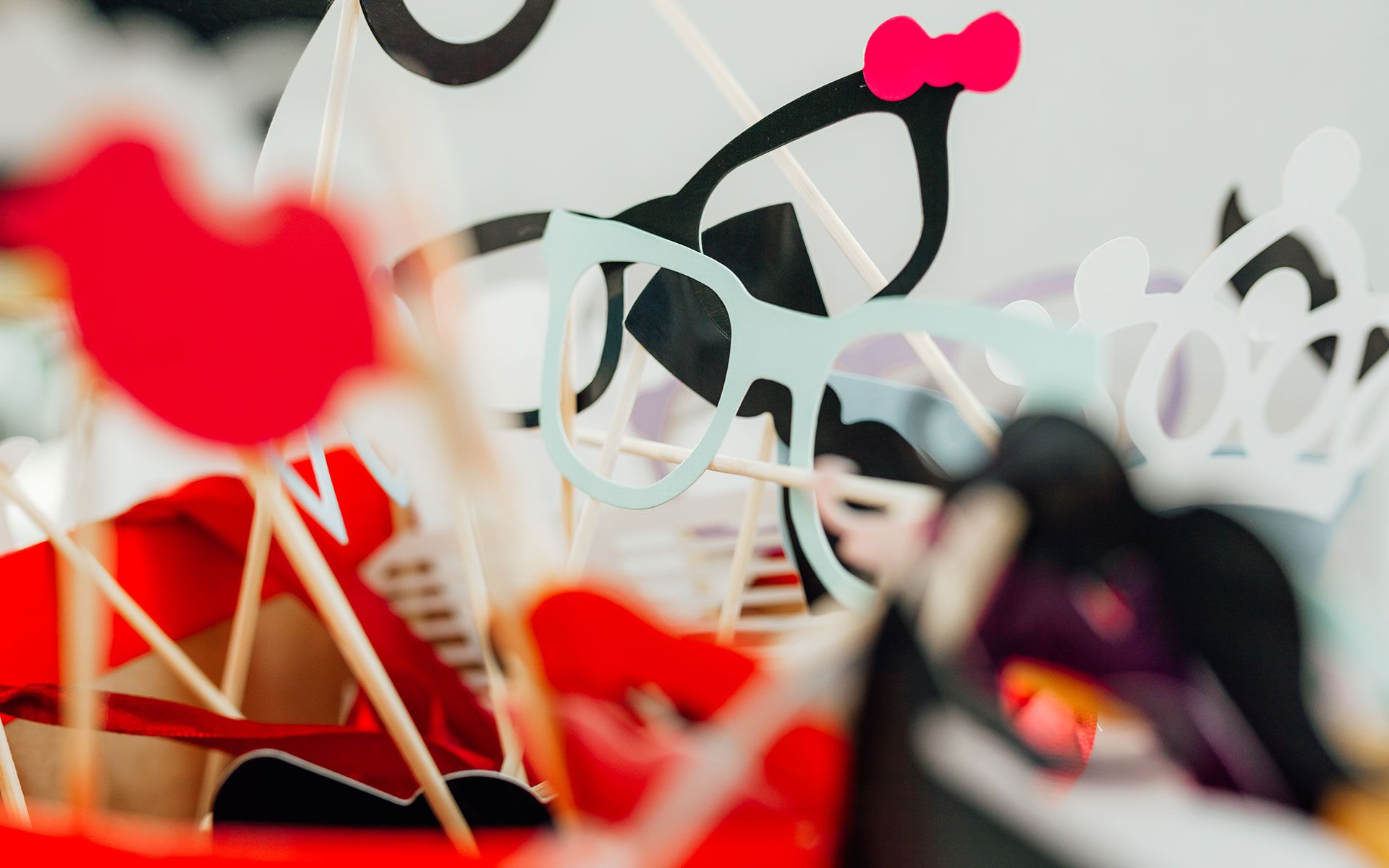 A bunch of photo booth props are sitting on a table.