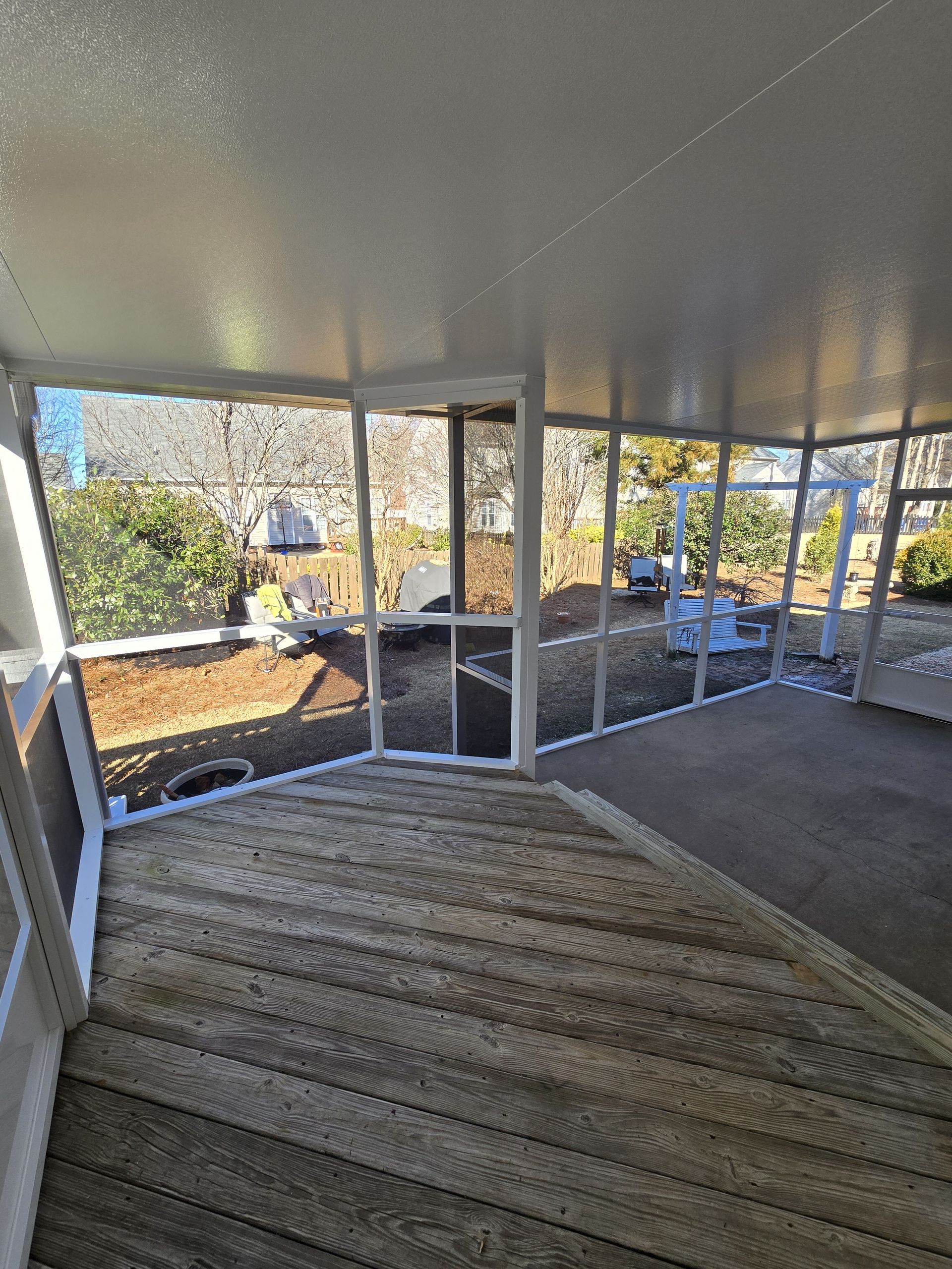 A room with a lot of windows and stairs leading up to it.