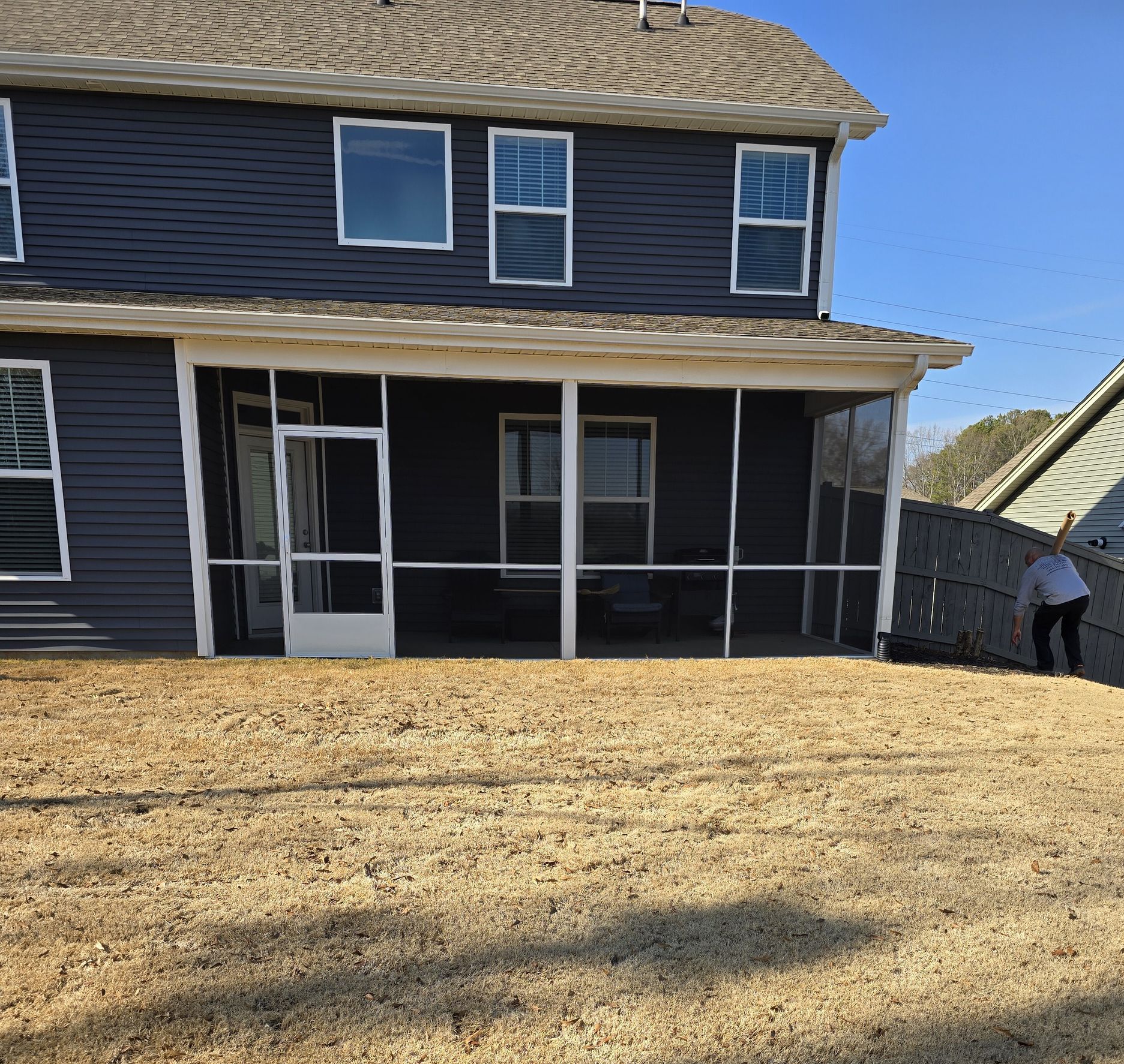The back of a house with a screened in porch