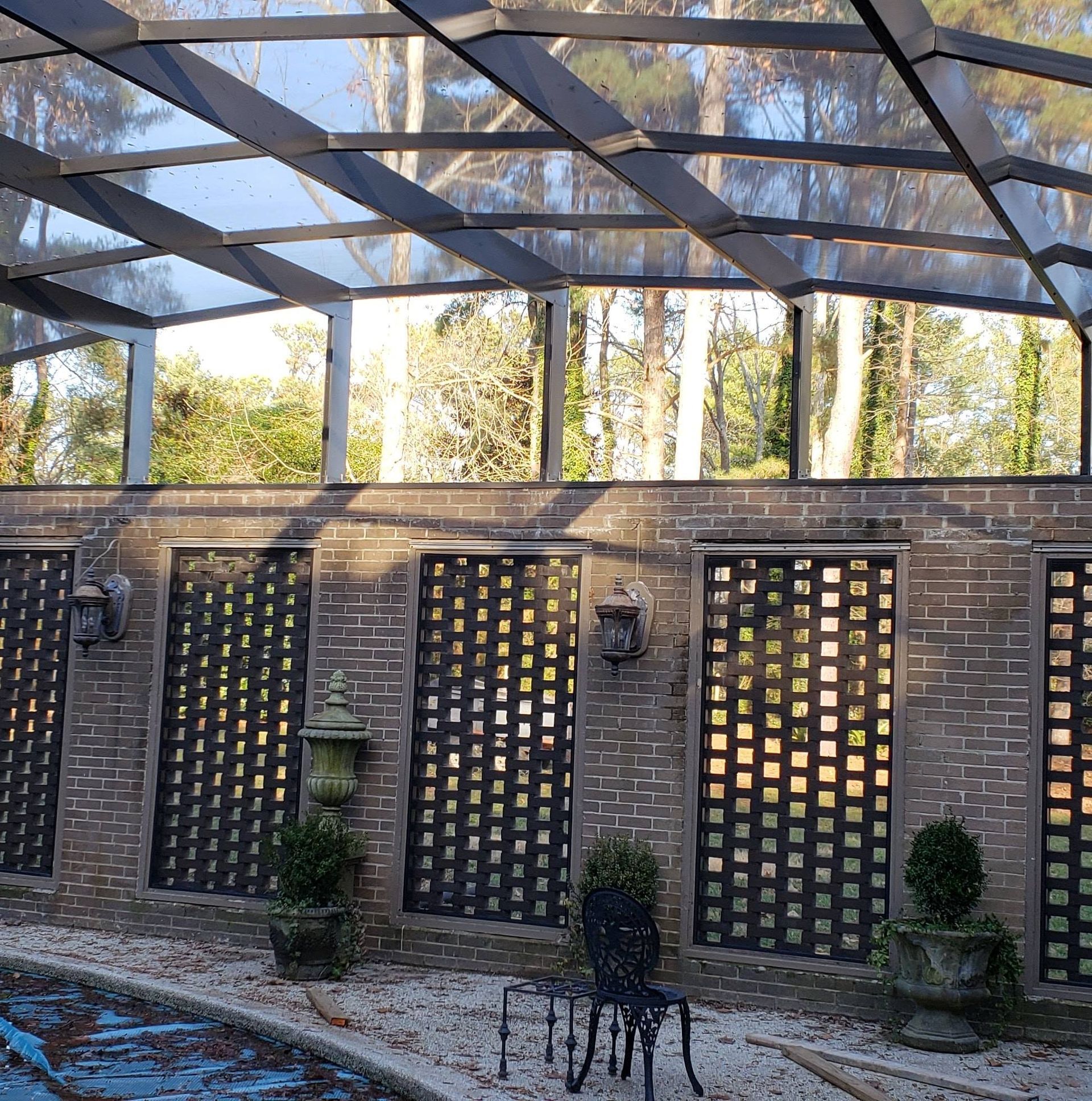 A brick building with a glass roof and a chair in front of it