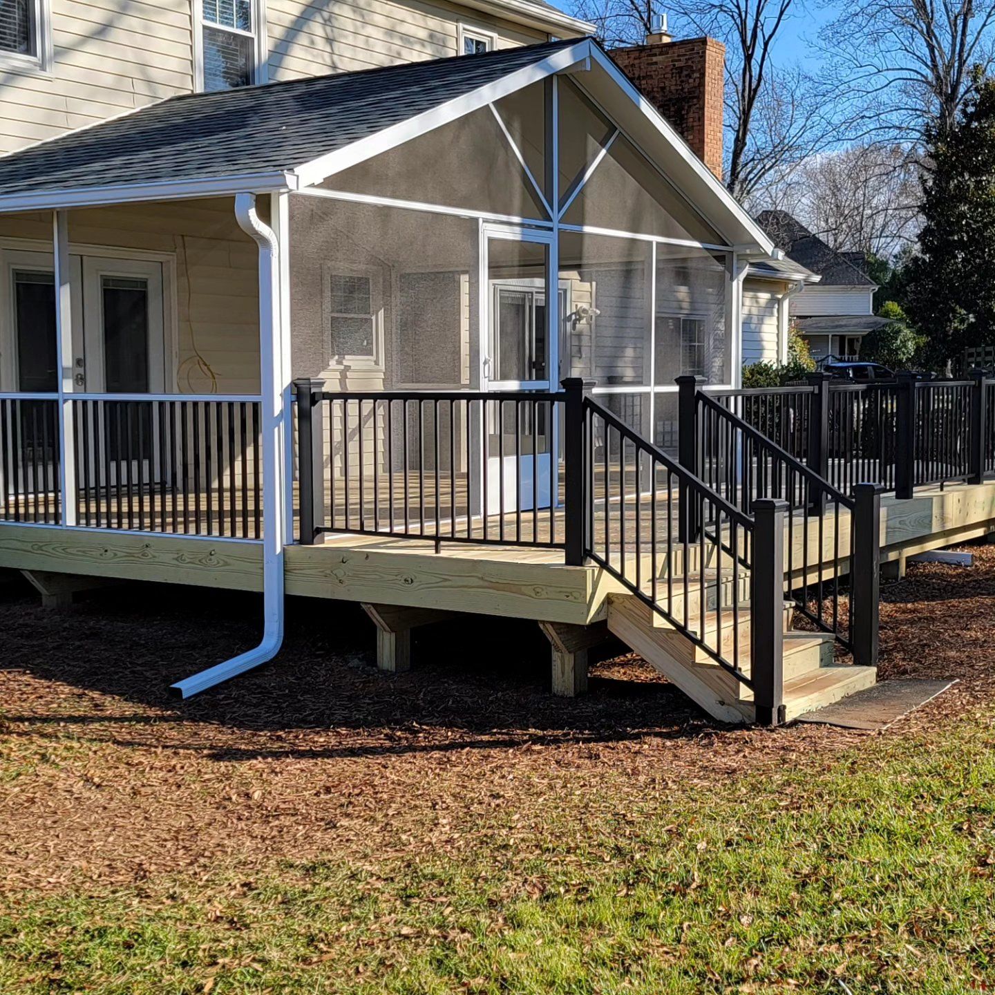 A screened in porch with stairs leading up to it