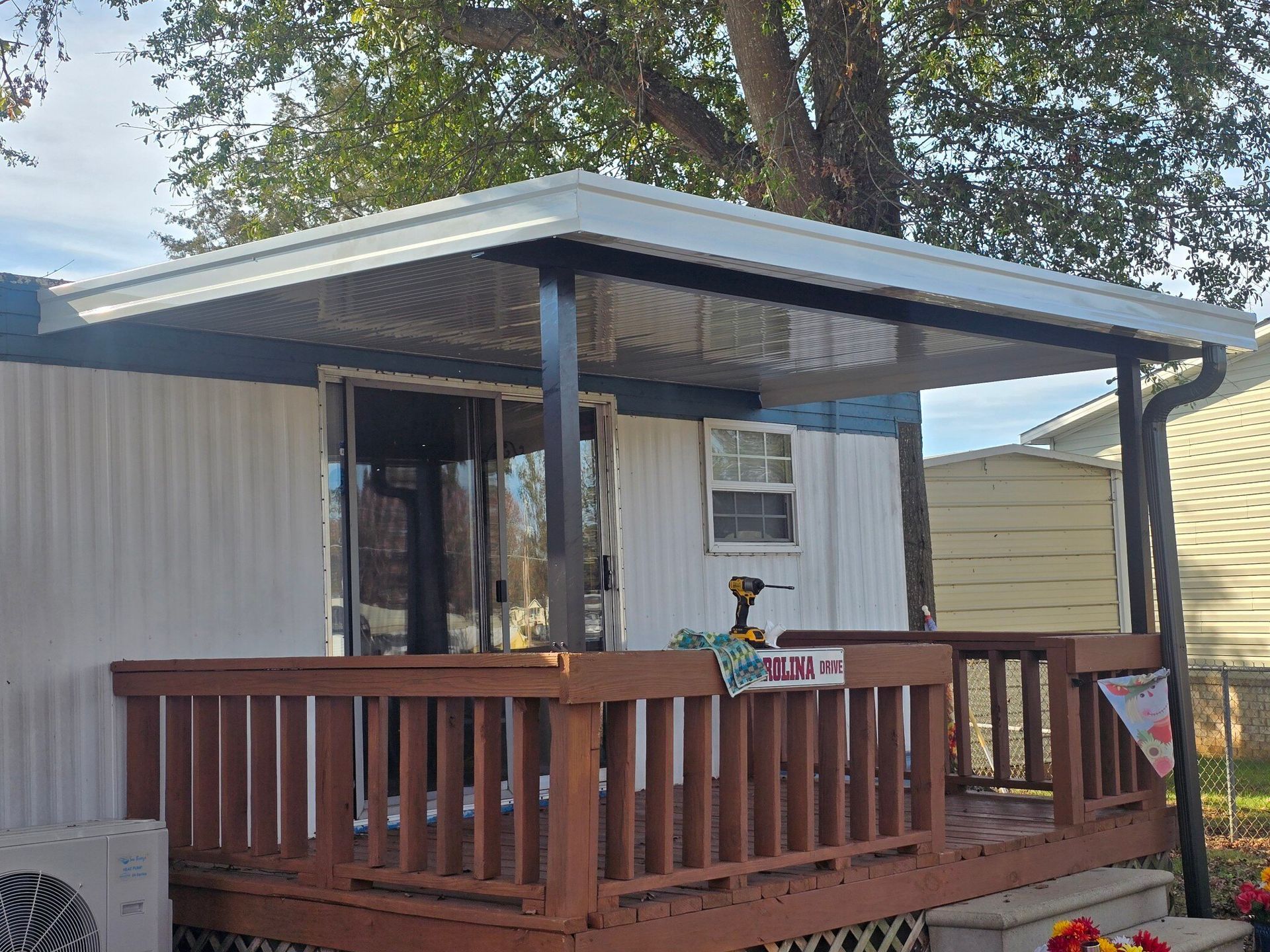 A mobile home with a porch and a roof.