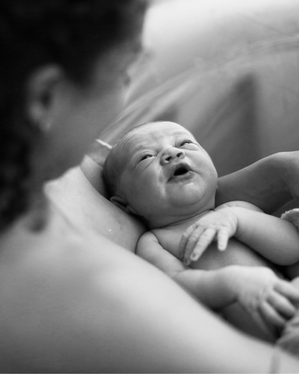 Woman with newborn in birth pool
