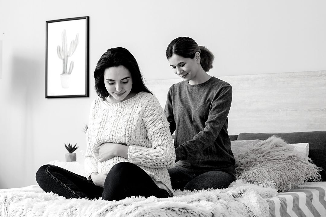A Doula Supporting a Pregnant Woman with Massage