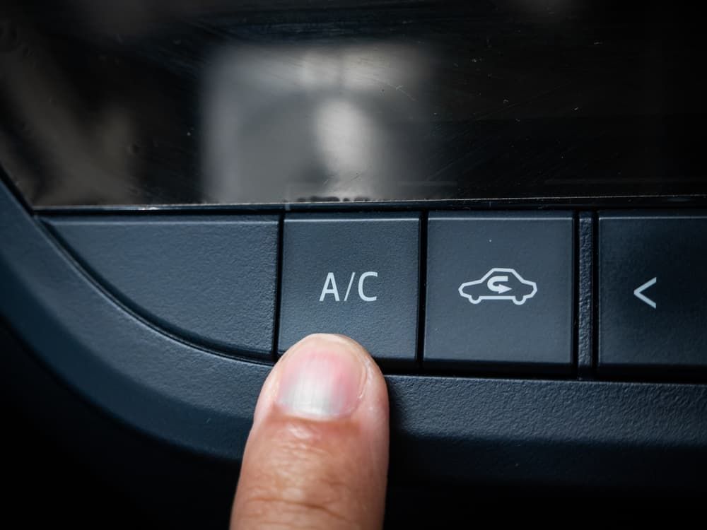 A Person is Pressing the A/C Button on a Car Dashboard — Waring's Auto Electrical in South Geelong, VIC