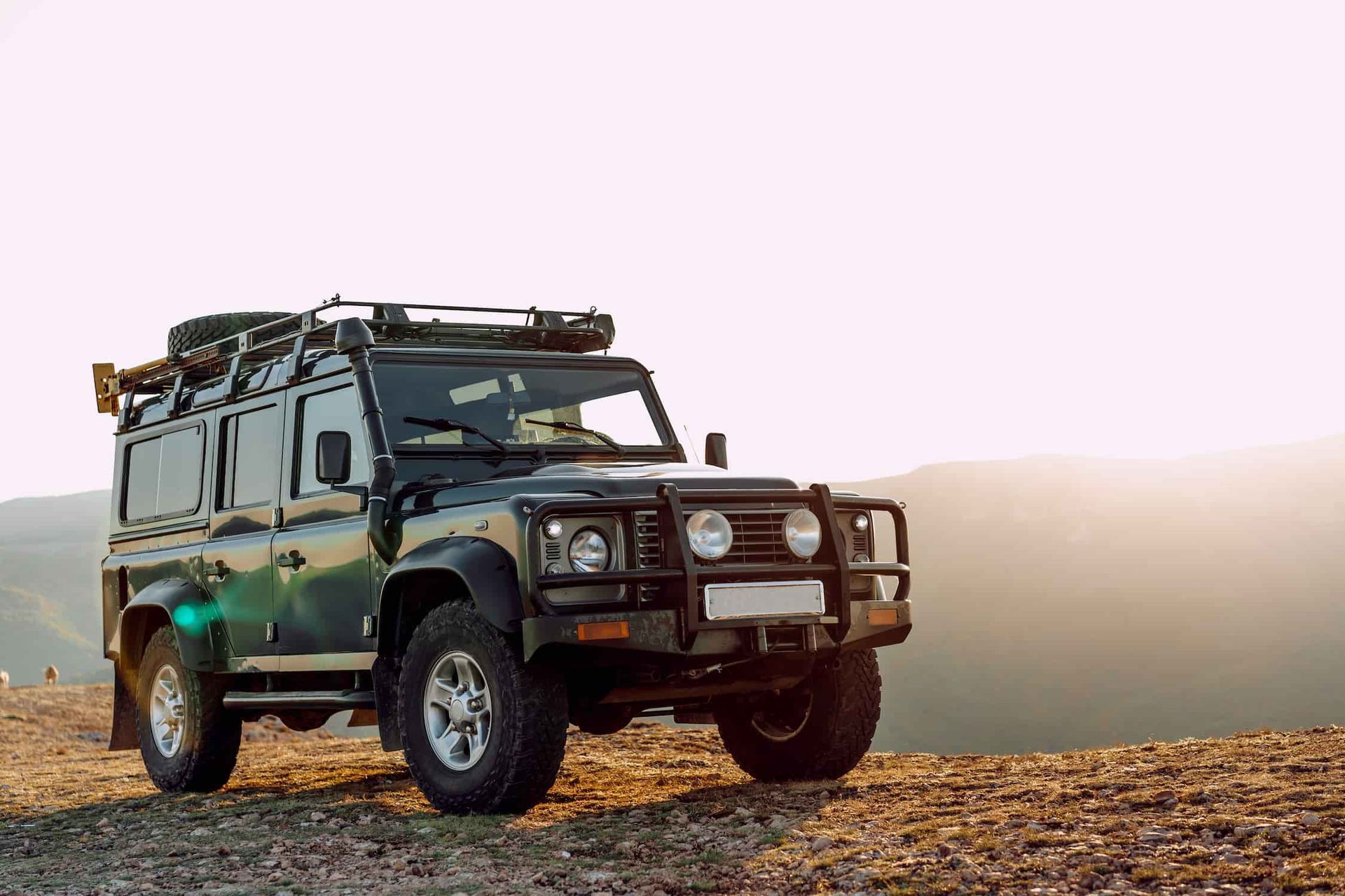 A Black Jeep is Parked on Top of a Dirt Hill — Waring's Auto Electrical in South Geelong, VIC