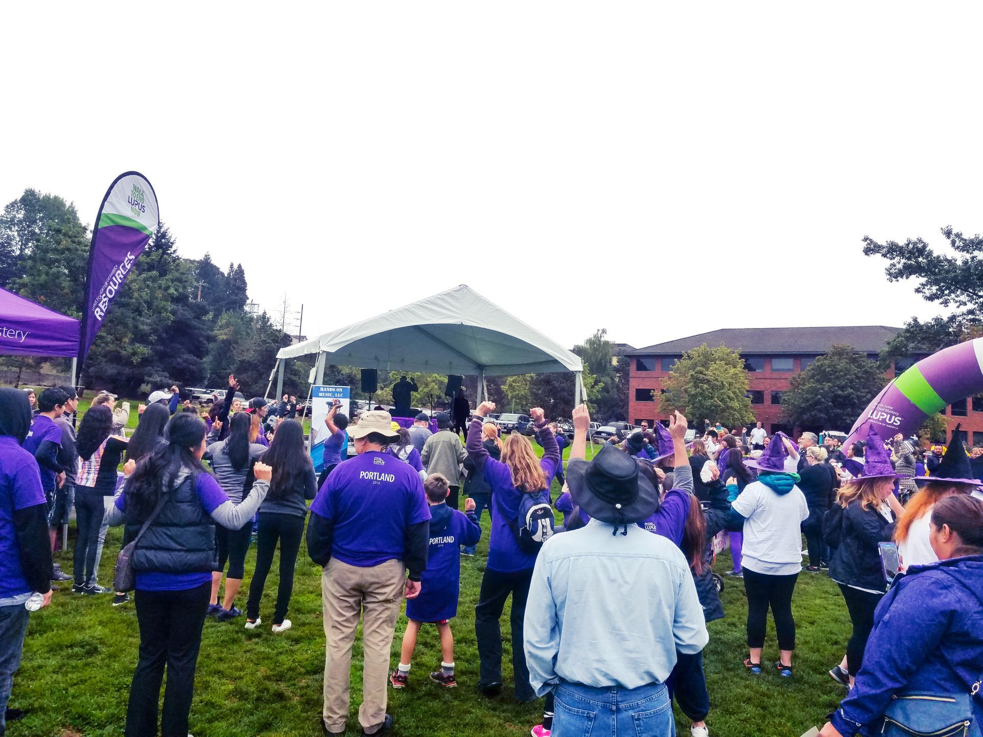 A picture taken from the back of the crowd looking towards the stage at the End Lupus Now event in Portland, Oregon.