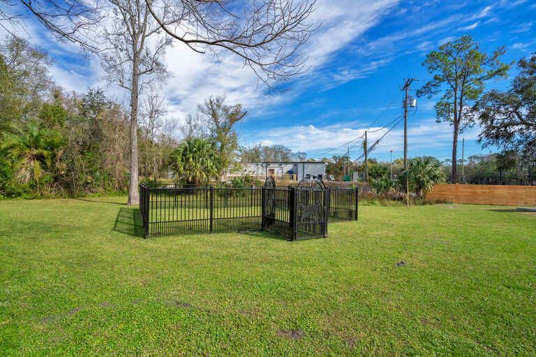There is a fence in the middle of a lush green field.