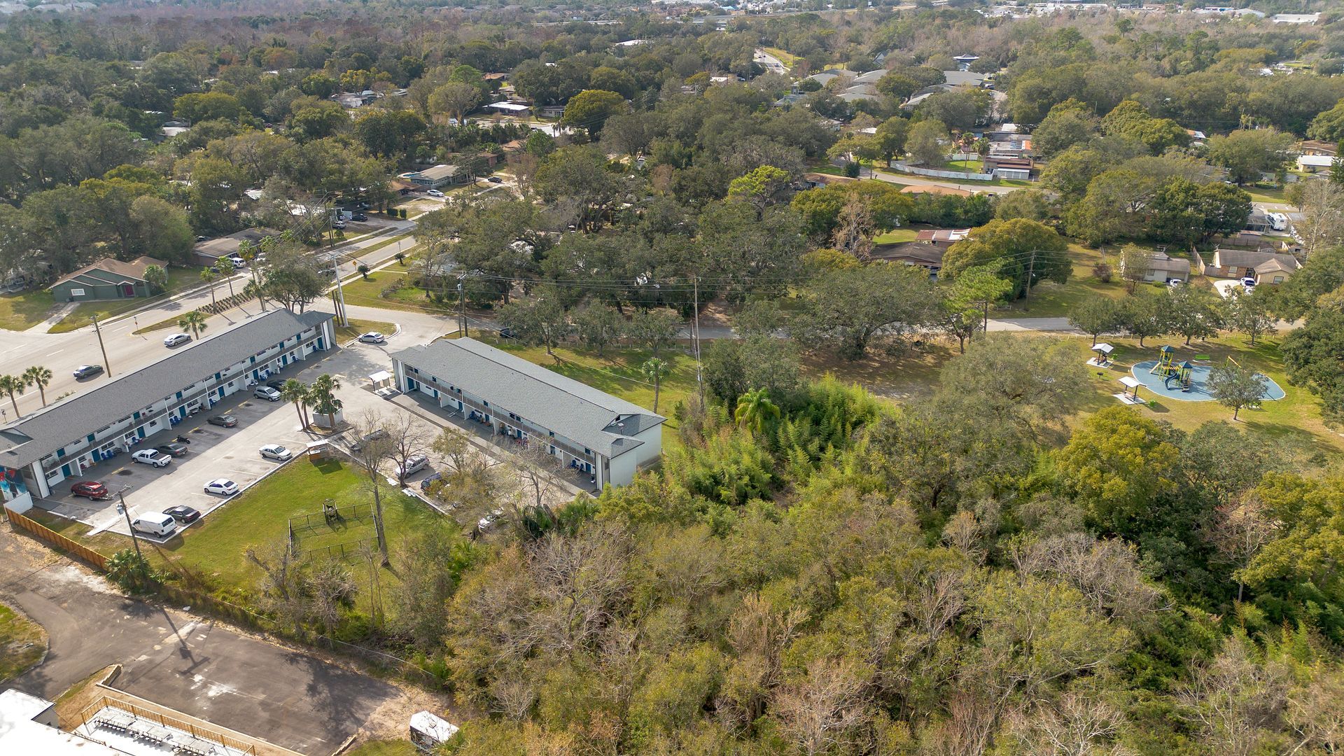 An aerial view of a residential area with lots of trees and buildings.