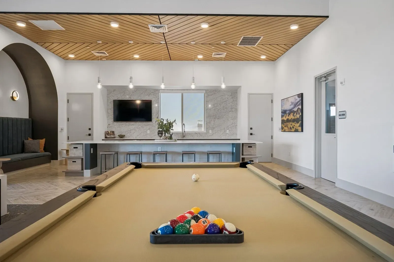 Enjoy a game of pool in the stylish lounge area, perfect for unwinding or socializing. This community amenity features a full-size pool table, comfortable seating, and a modern bar.
