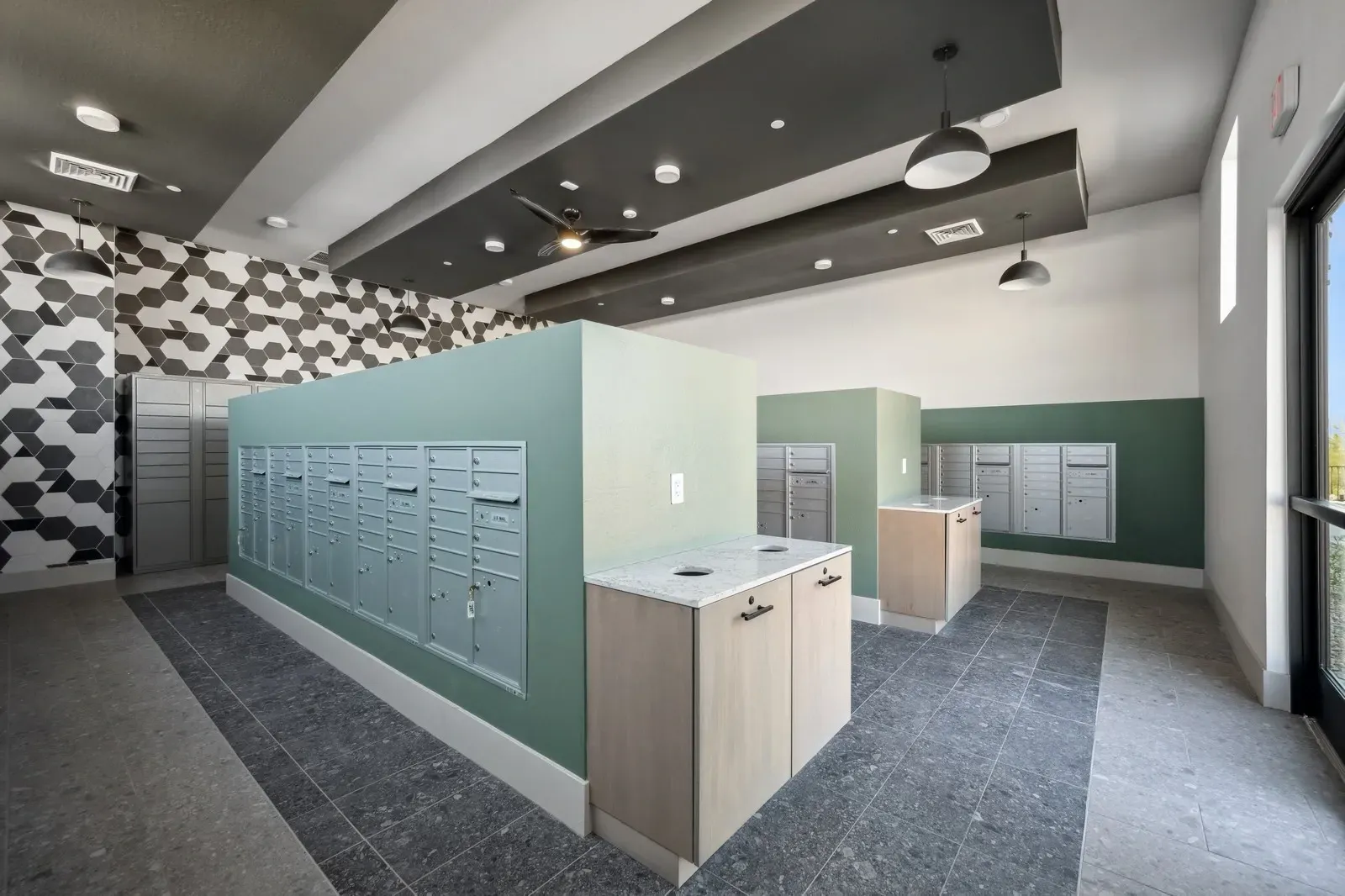 Secure and stylish mailroom featuring multiple rows of mailboxes and a modern accent wall for resident convenience.