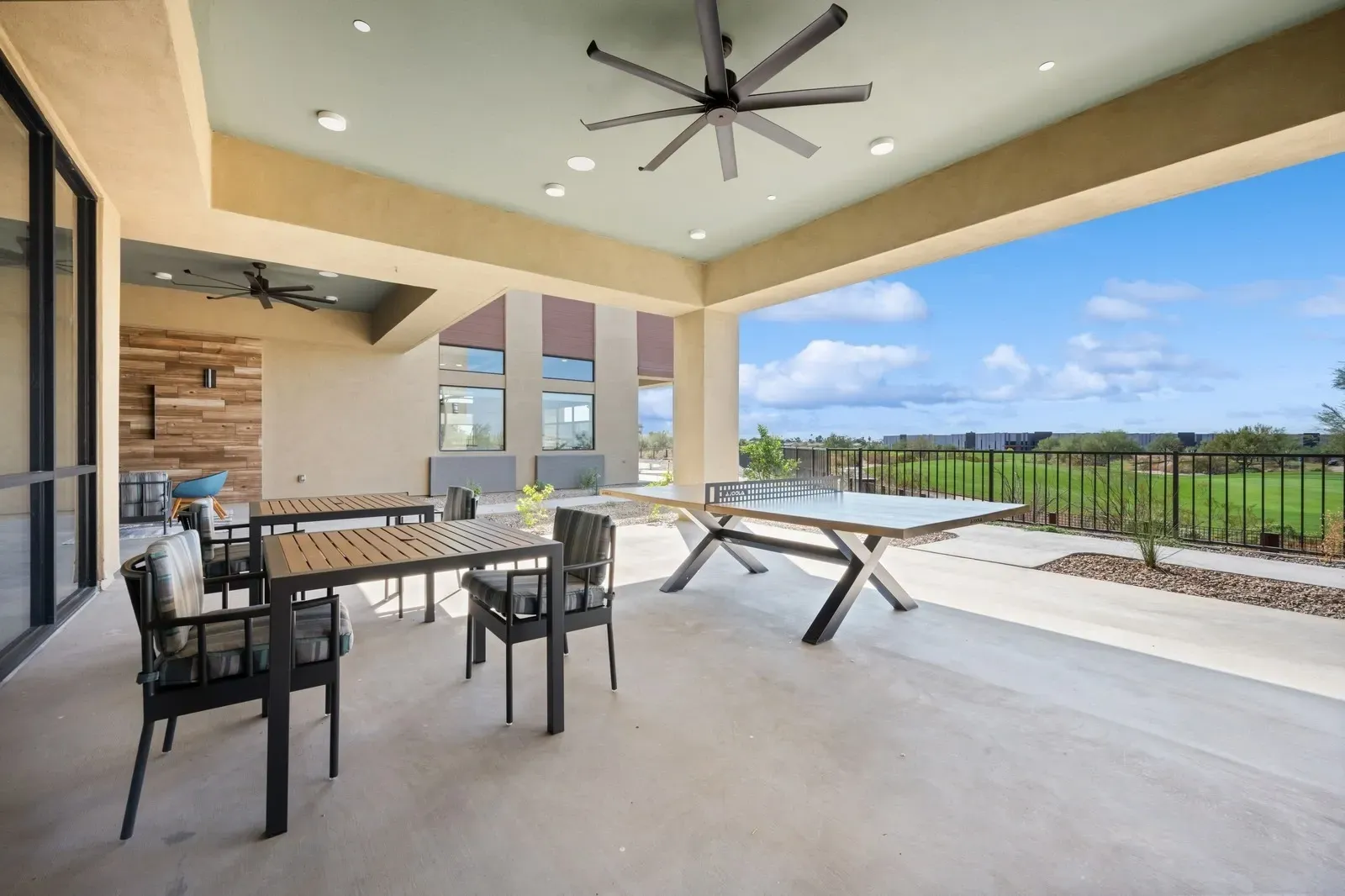 Enjoy recreational activities and scenic views from the community's covered outdoor patio, complete with a ping pong table and comfortable seating.