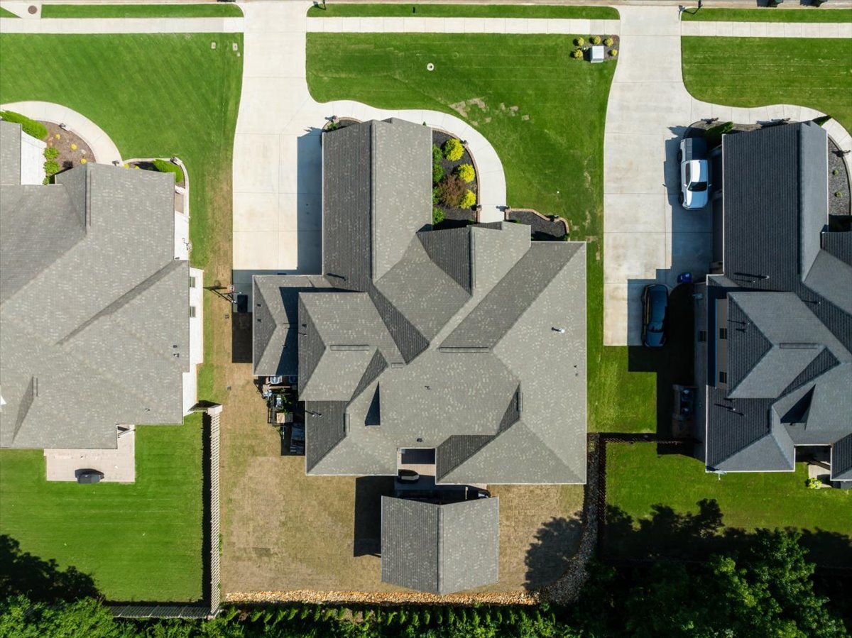An aerial view of a residential neighborhood with houses and driveways.