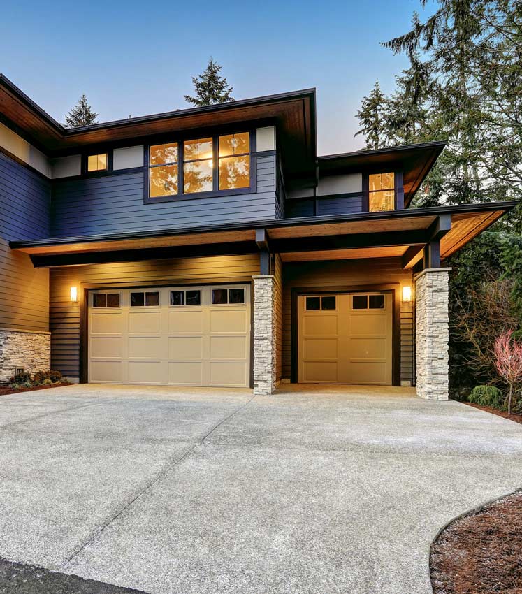 a large house with two garage doors and a driveway