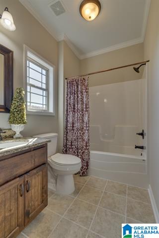 a bathroom with a toilet , sink , shower and window .